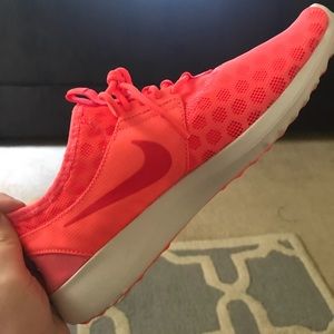 Women’s neon coral Nike shoes